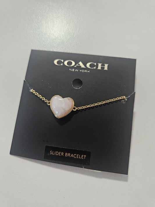 Pulsera Coach en forma de corazon ajustable